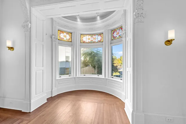 an entryway to room with wooden floor and windows