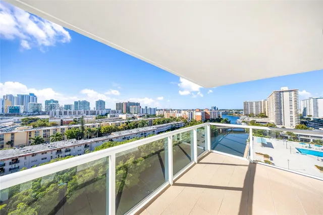 a view of a city from a chairs and table in a terrace