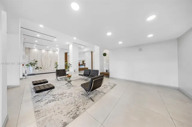 a lobby with furniture and a potted plant