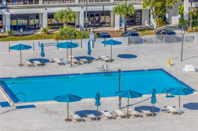 a view of a swimming pool with outdoor seating