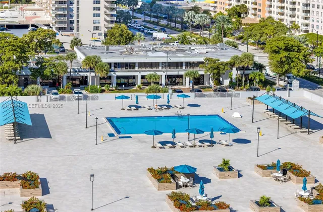 a kitchen with stainless steel appliances kitchen island granite countertop a table chairs in it and wooden floor