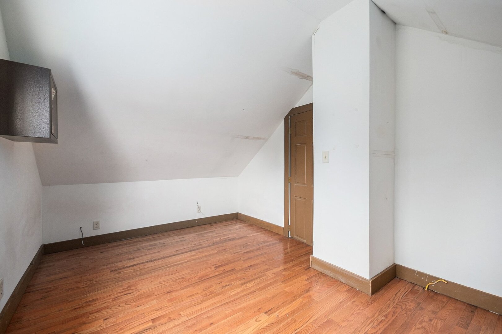 265 Monroe Street Gardner, IL 60424 - Photo 16 of 25 a view of an empty room with wooden floor and a hallway