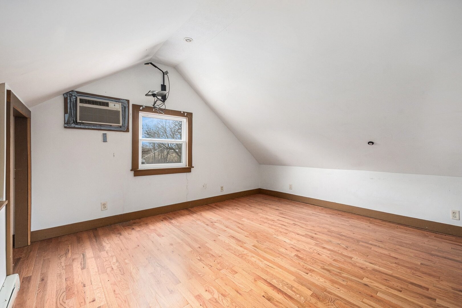265 Monroe Street Gardner, IL 60424 - Photo 18 of 25 a view of an empty room with wooden floor and a window