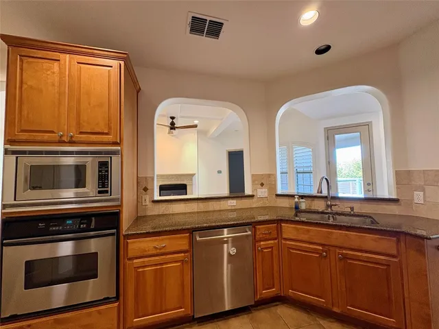 a kitchen with stainless steel appliances granite countertop a stove and a microwave