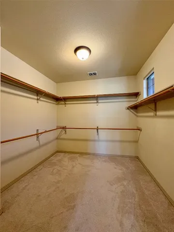 a view of an empty room with a ceiling fan