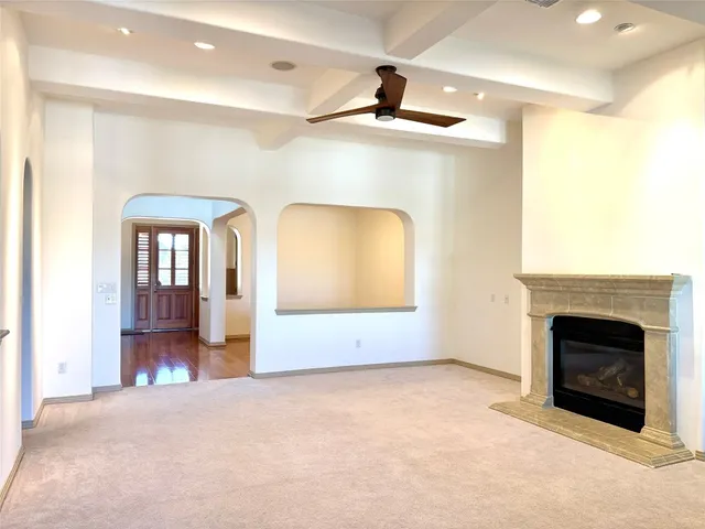 a view of a livingroom with a fireplace and window