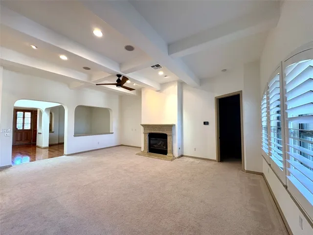 an empty room with furniture and a fireplace