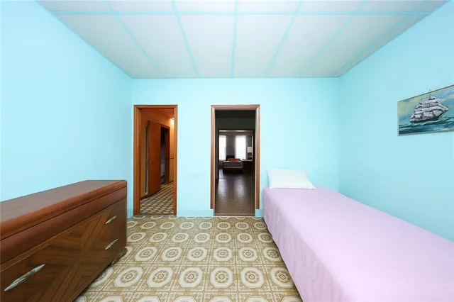 a bedroom with a bed and a dresser