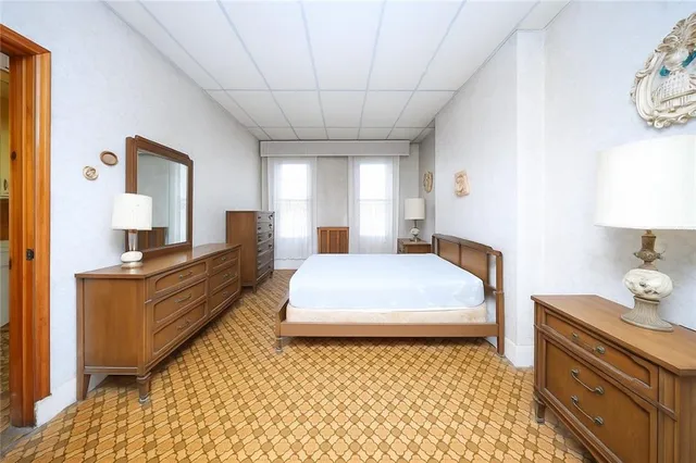 a large bedroom with a bed and window