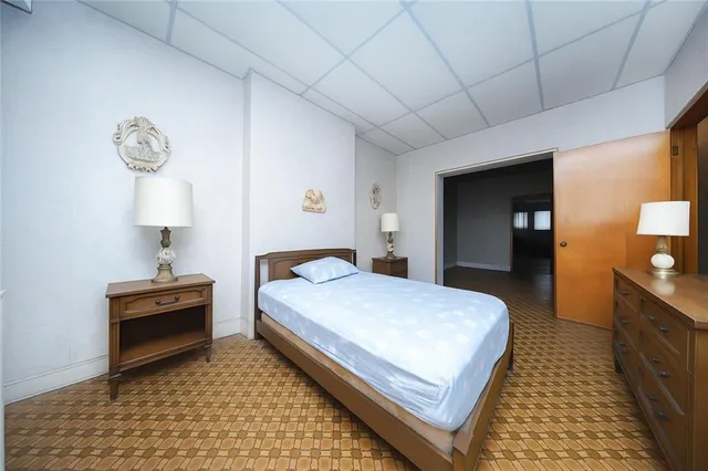 a bedroom with a bed and a lamp on table