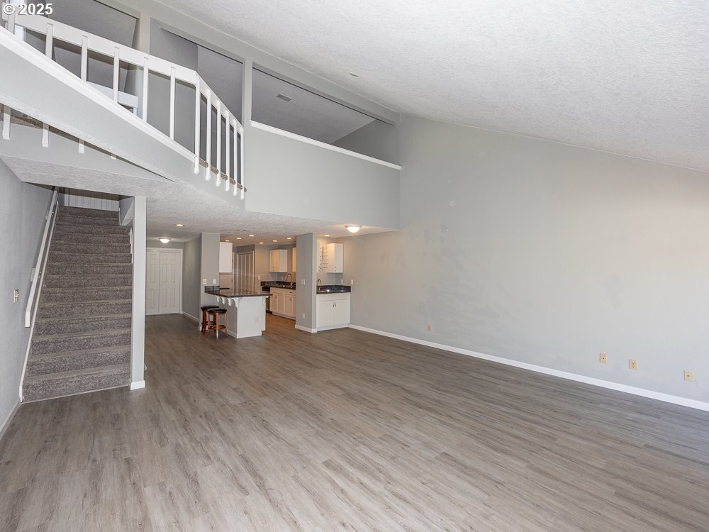 3318 Northeast 29th Street Gresham, OR 97030 - Photo 16 of 32 a view of an empty room with stairs and a living room