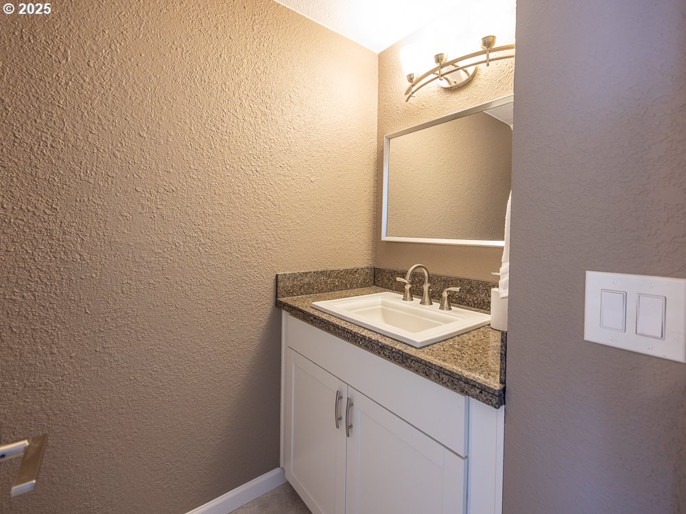 3318 Northeast 29th Street Gresham, OR 97030 - Photo 27 of 32 a bathroom with a granite countertop sink and a mirror