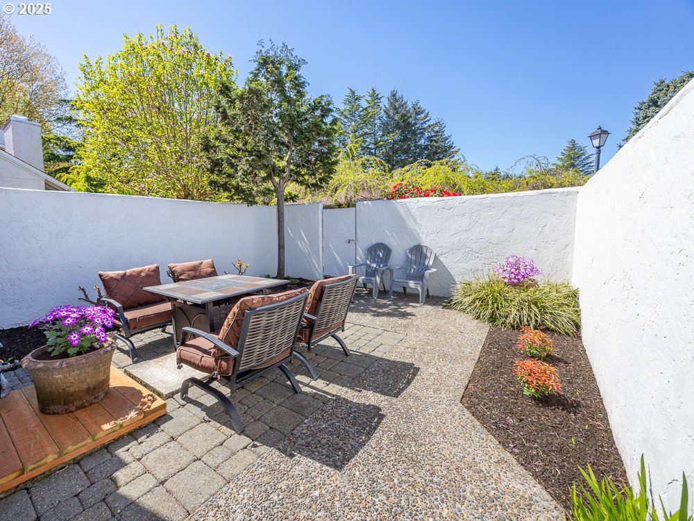 3318 Northeast 29th Street Gresham, OR 97030 - Photo 28 of 32 a backyard of a house with table and chairs plants