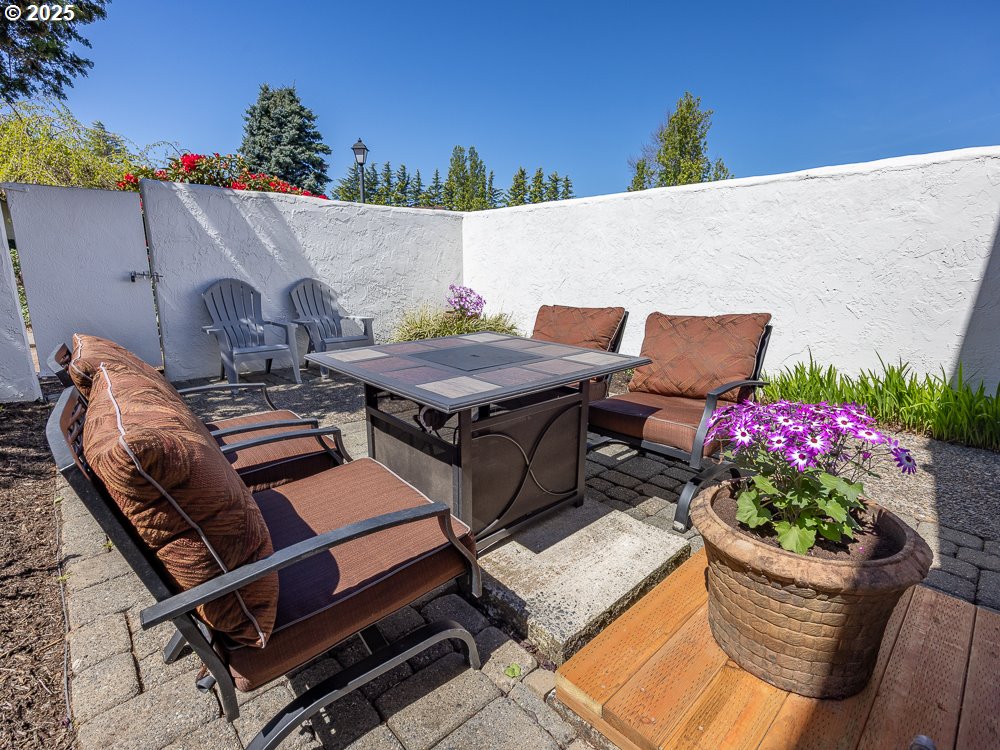3318 Northeast 29th Street Gresham, OR 97030 - Photo 29 of 32 a roof deck with table and chairs potted plants and a large window