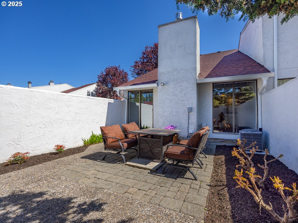 3318 Northeast 29th Street Gresham, OR 97030 - Photo 30 of 32 a view of a patio with table and chairs under an umbrella