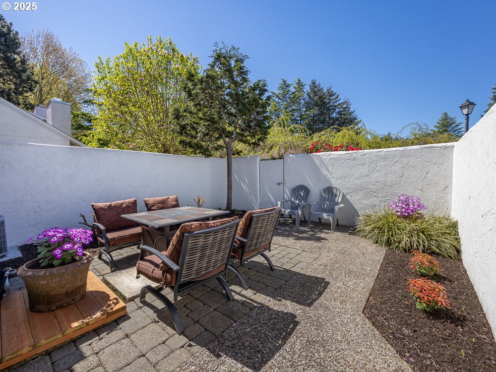 3318 Northeast 29th Street Gresham, OR 97030 - Photo 31 of 32 a view of a patio with table and chairs potted plants
