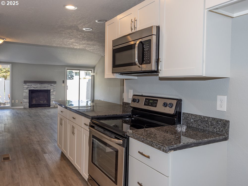 3318 Northeast 29th Street Gresham, OR 97030 - Photo 6 of 32 a kitchen with granite countertop a sink and a stove top oven