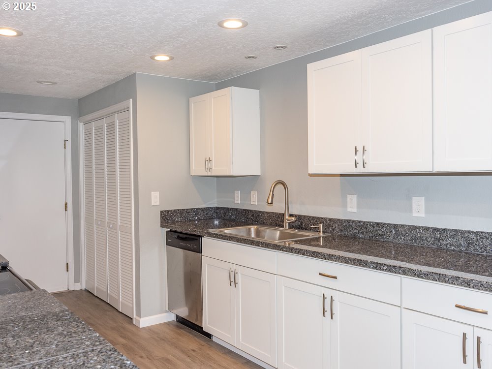 3318 Northeast 29th Street Gresham, OR 97030 - Photo 7 of 32 a kitchen with granite countertop white cabinets and sink