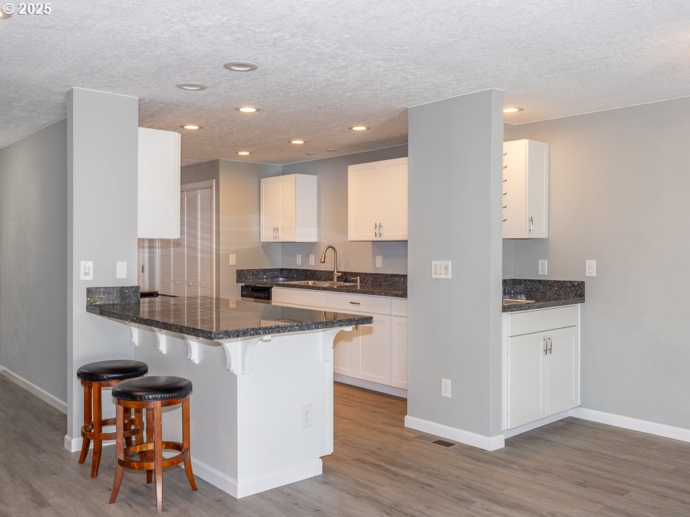 3318 Northeast 29th Street Gresham, OR 97030 - Photo 10 of 32 a kitchen with a sink cabinets and wooden floor