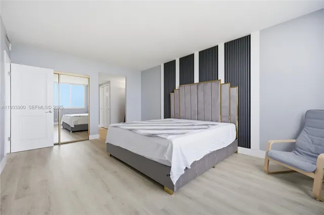 a spacious bedroom with a bed couch and a window