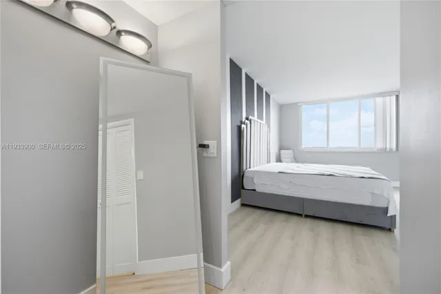 a spacious bedroom with a bed and a window