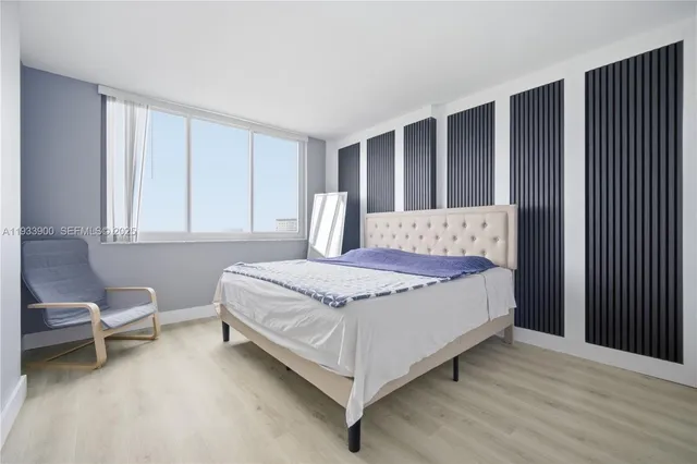 a bedroom with a bed chair and window