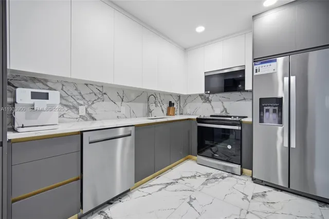 a kitchen with a refrigerator and a sink