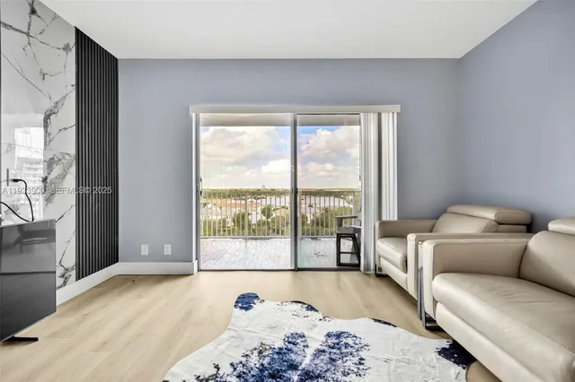 a bedroom with furniture and a large window