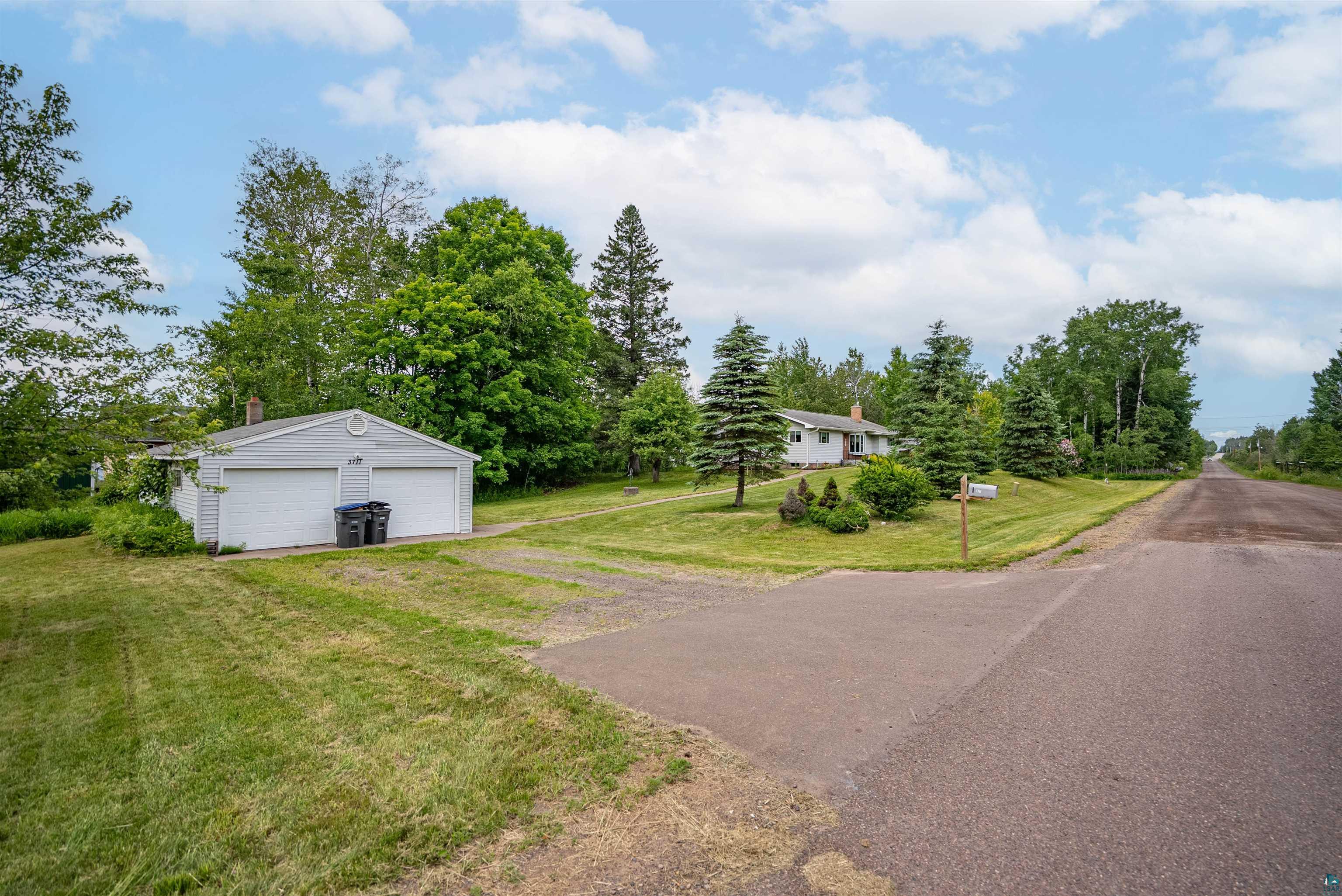 3711 Getchell Road Hermantown, MN 55811 - Photo 25 of 31 Detached garage with two white overhead doors and a gravel driveway