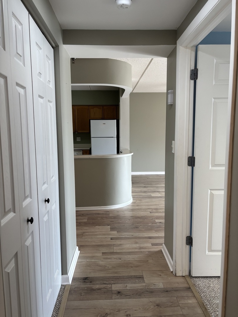 3303 Grove Avenue, Unit 310 Berwyn, IL 60402 - Photo 18 of 21 a view of a hallway with wooden floor and staircase