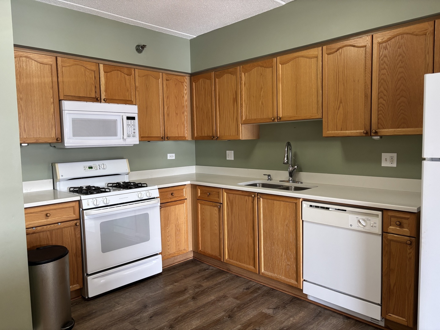 3303 Grove Avenue, Unit 310 Berwyn, IL 60402 - Photo 7 of 21 a kitchen with stainless steel appliances granite countertop a stove a sink and a microwave