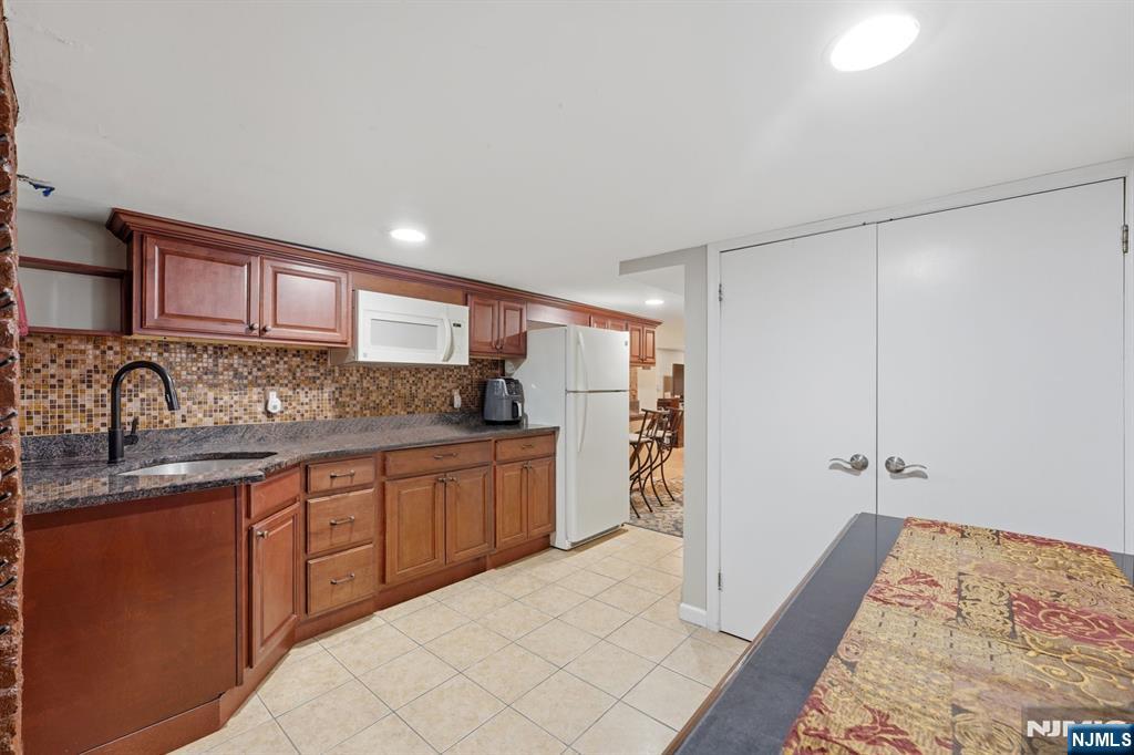 385 Berkeley Avenue Bloomfield, NJ 07003 - Photo 24 of 39 a kitchen with granite countertop a sink and cabinets