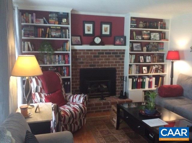 1637 Buckner Road Bumpass, VA 23024 - Photo 2 of 14 a living room with furniture a rug and a bookshelf