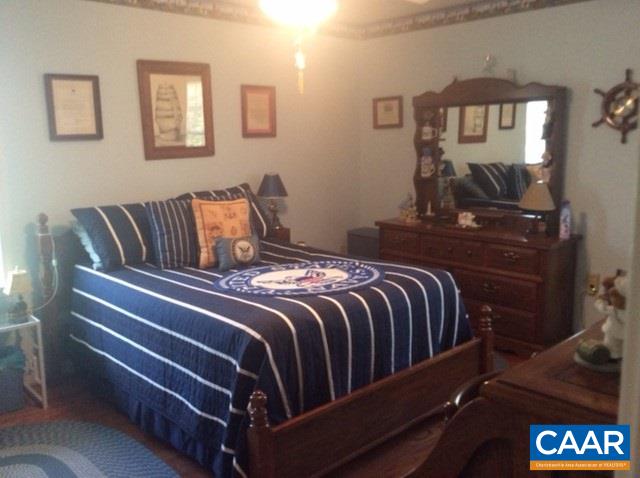 1637 Buckner Road Bumpass, VA 23024 - Photo 8 of 14 a bedroom with a bed and window
