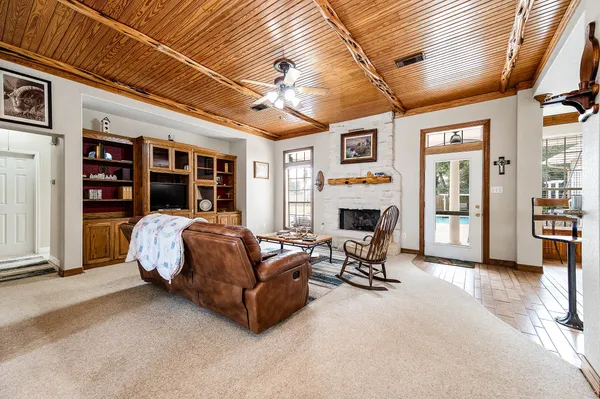 a living room with furniture gym equipment and a fireplace