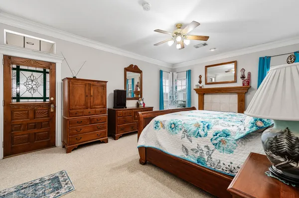 a bed sitting in a bedroom and dresser