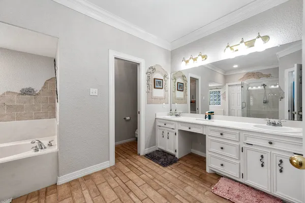 a spacious bathroom with a double vanity sink a mirror and a bathtub