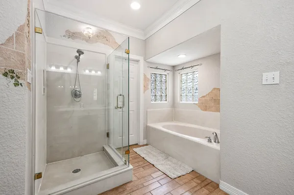 a bathroom with a bathtub shower and toilet
