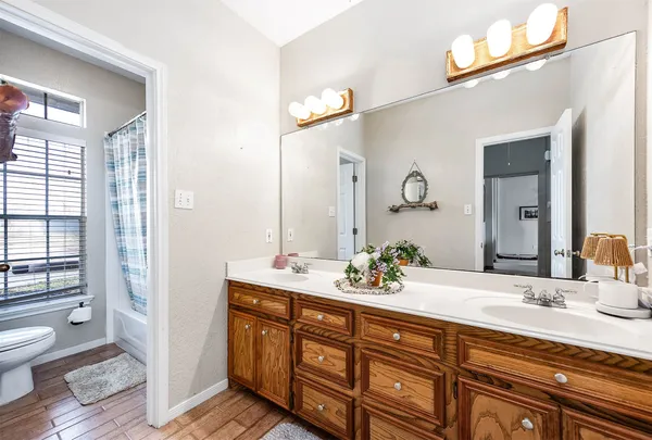 a bathroom with a double vanity sink and a mirror