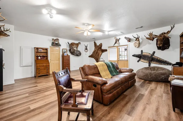 a living room with furniture and a wooden floor