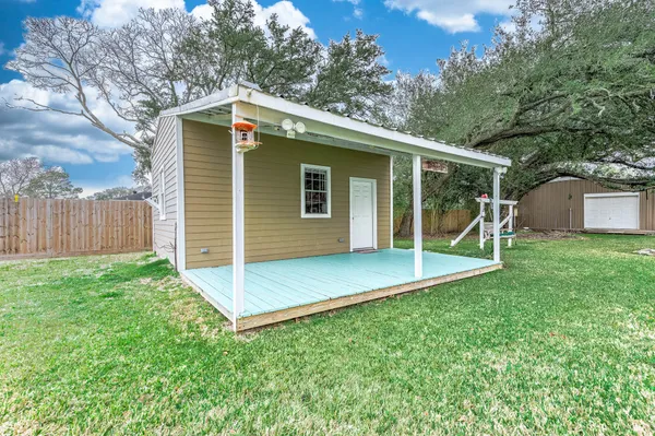 a view of a backyard with a garden and entertaining space
