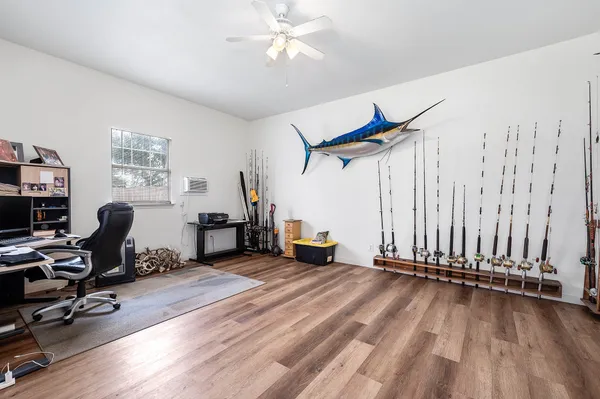 a view of a workspace with furniture and a window