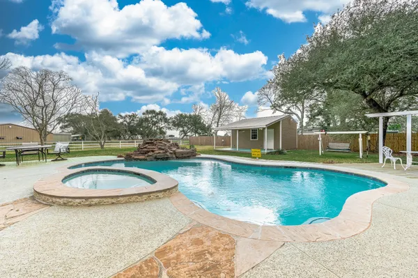 a view of a swimming pool with a yard