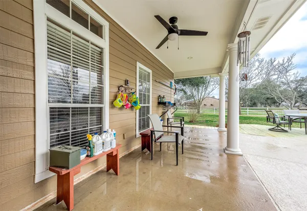 a view of a patio with a table chairs and a backyard
