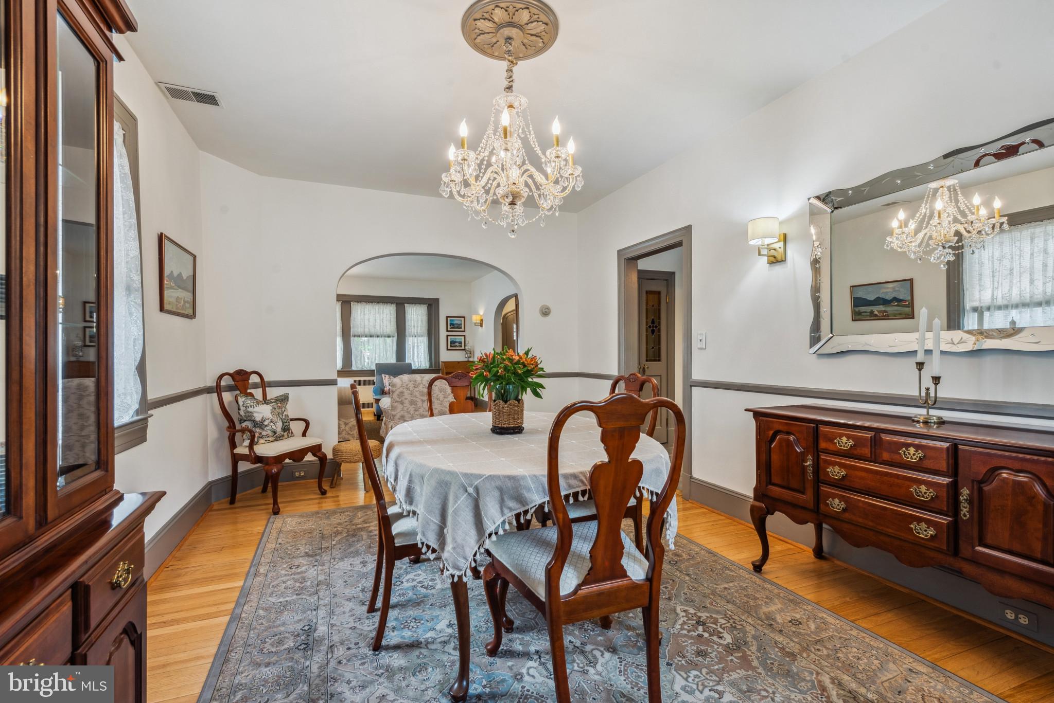 401 Hopkins Road Baltimore, MD 21212 - Photo 16 of 63 a view of a dining room with furniture a chandelier and wooden floor