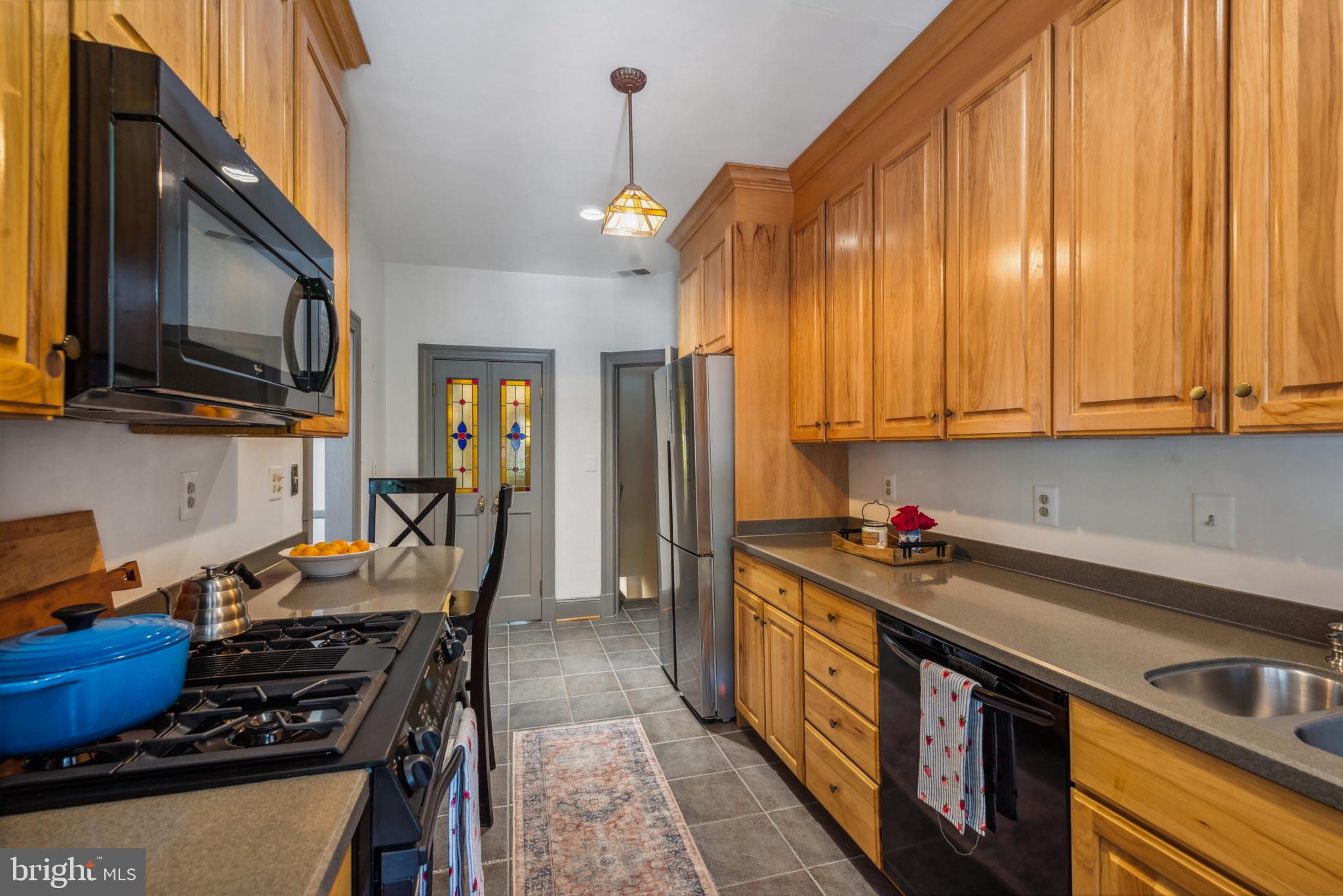 401 Hopkins Road Baltimore, MD 21212 - Photo 19 of 63 a kitchen with stainless steel appliances a stove a sink dishwasher and cabinets with wooden floor