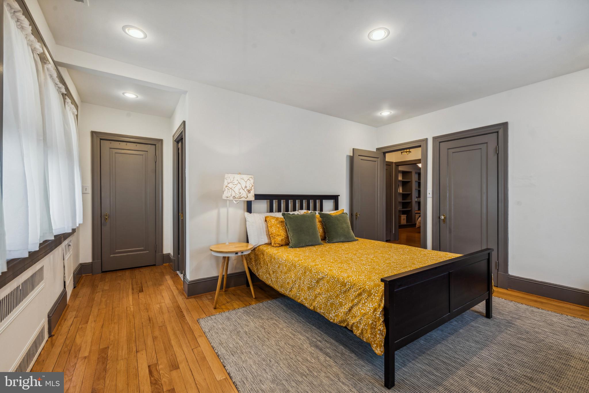 401 Hopkins Road Baltimore, MD 21212 - Photo 32 of 63 a bedroom with a bed and wooden floor