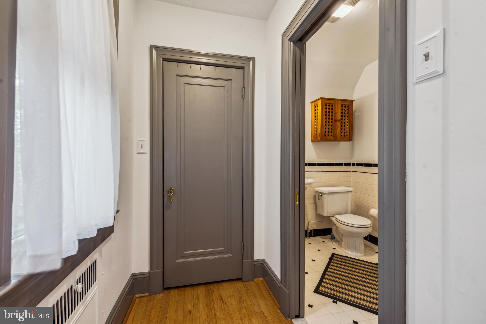 401 Hopkins Road Baltimore, MD 21212 - Photo 36 of 63 Bathroom with toilet, a wainscoted wall, tile wall