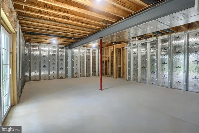 a view of empty room with wooden walls