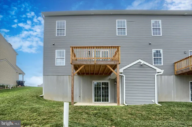a view of a house with brick walls and a yard